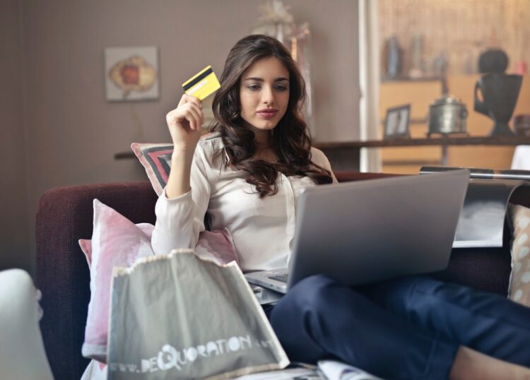 https://www.pexels.com/photo/woman-holding-card-while-operating-silver-laptop-919436/